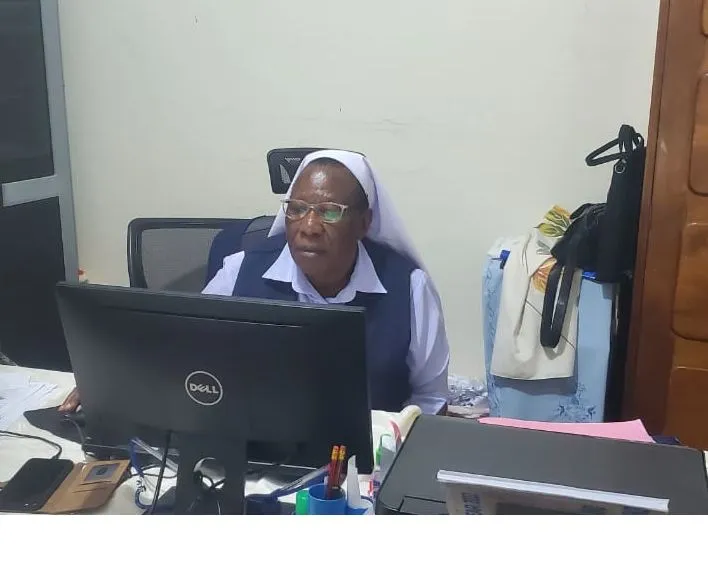 Sr. Atuhaire Angelica, Bursar, at her desk in the school office
